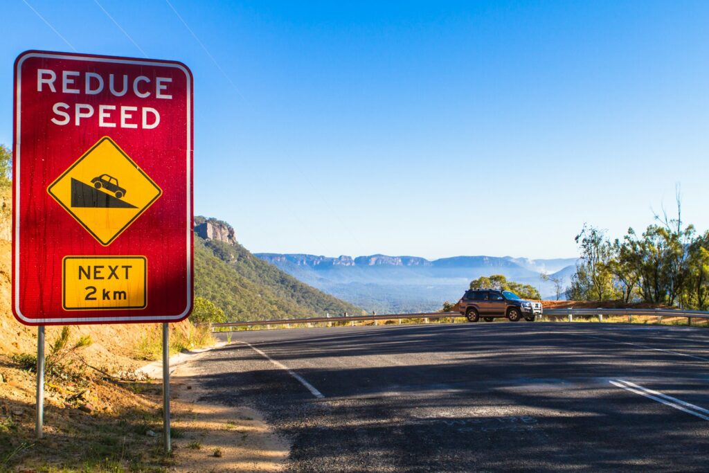 reduce speed road sign